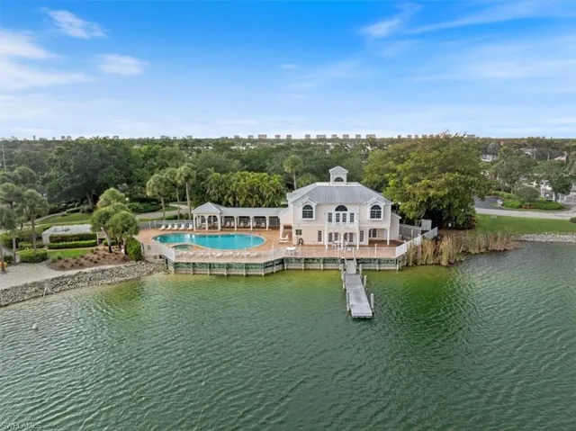View of Community clubhouse, pool and spa, fishing pier