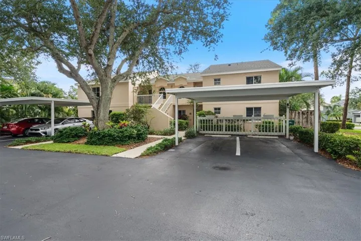 View of front of house featuring covered assigned parking spot
