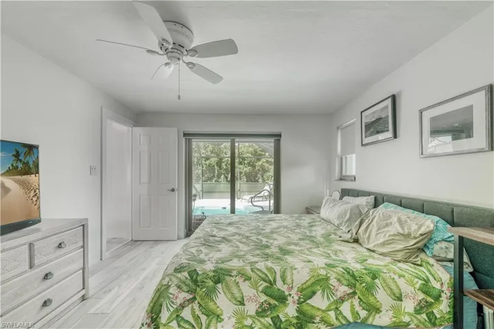 Bedroom with ceiling fan, access to outside, and light wood-style floors