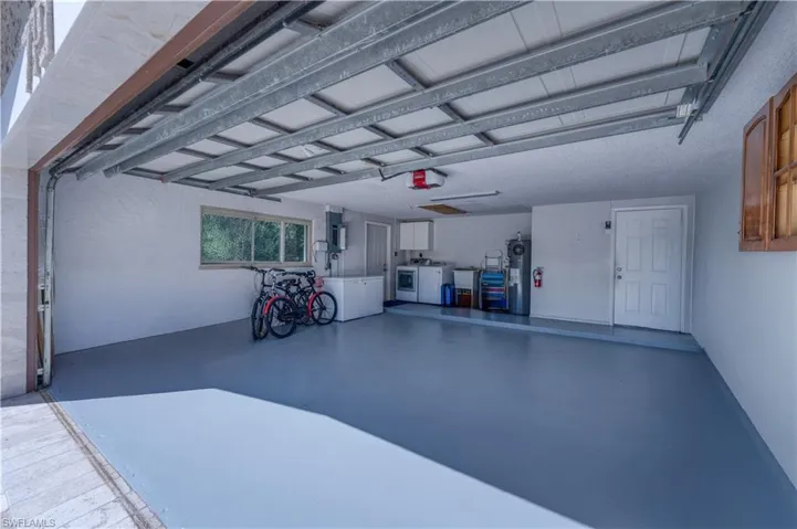 Garage featuring washer and clothes dryer and a garage door opener
