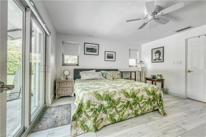 Bedroom featuring visible vents, access to exterior, and multiple windows