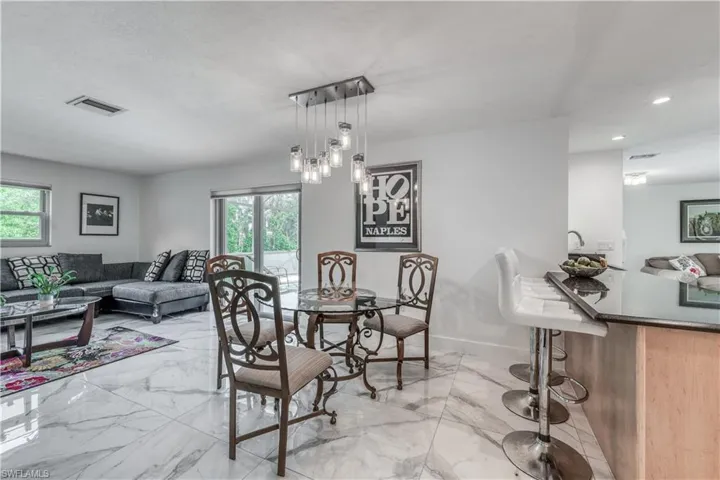 Dining space with visible vents, plenty of natural light, and marble finish floor
