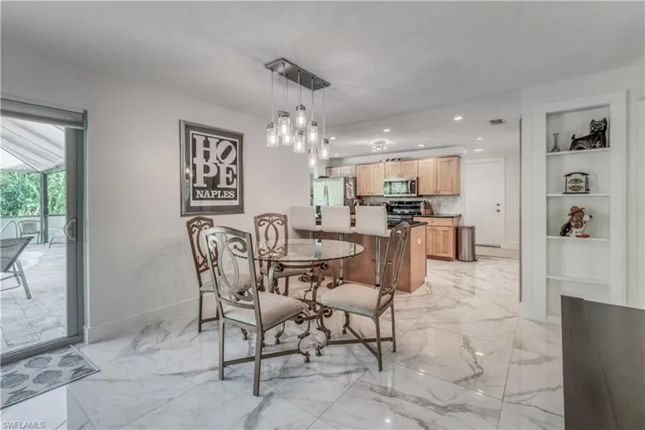 Dining space with recessed lighting, marble finish floor, visible vents, baseboards, and built in shelves