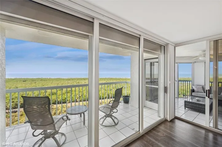 Sunroom / solarium featuring a water view, a wealth of natural light, and ceiling fan