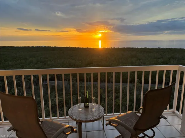 Balcony at dusk featuring a water view