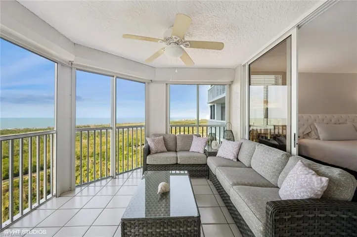 Sunroom / solarium with a water view and ceiling fan