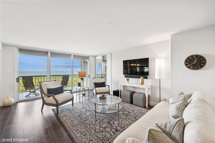 Living room with hardwood / wood-style flooring and floor to ceiling windows
