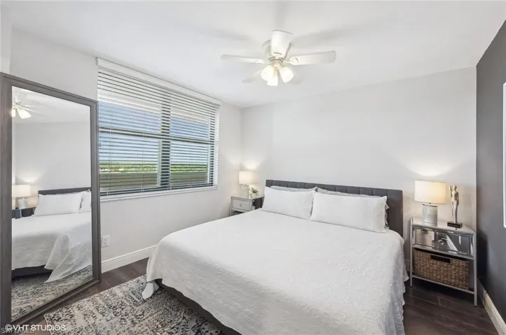 Bedroom featuring ceiling fan and dark hardwood / wood-style floors
