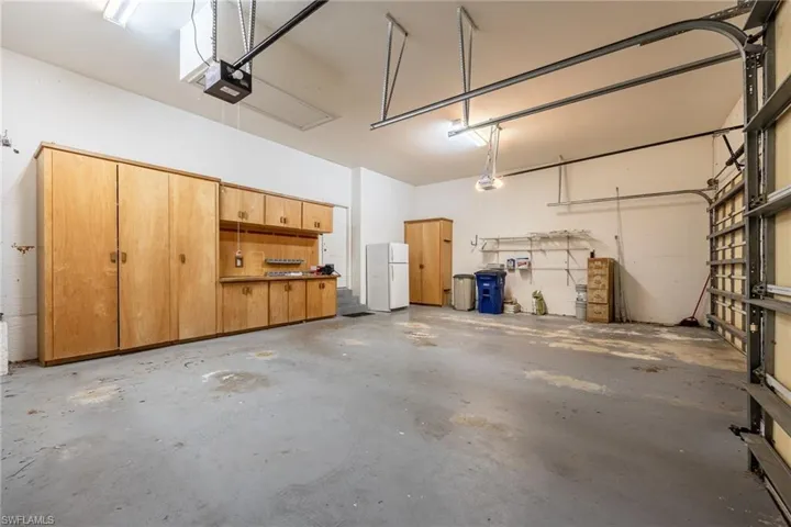 3 car garage with extra storage cabinets.