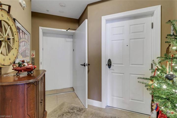 Foyer with private elevator opens in unit...