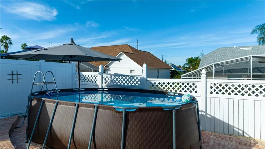 View of swimming pool with a fenced backyard, a deck, and a patio area