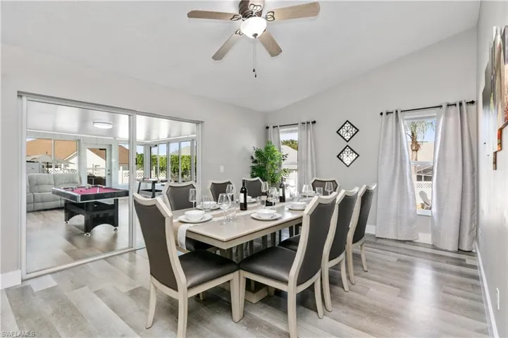 Dining space featuring lofted ceiling, light wood-type flooring, and a ceiling fan