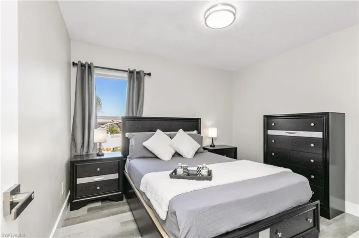 Bedroom featuring baseboards and light wood-type flooring
