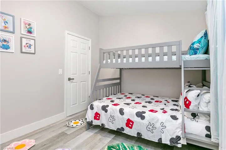 Bedroom featuring wood finished floors and baseboards