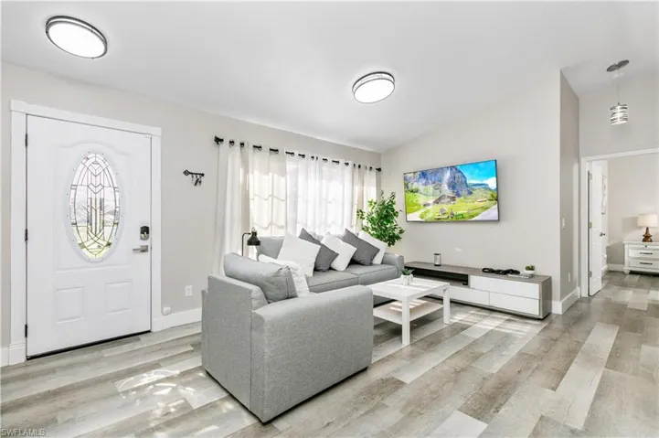Living area featuring vaulted ceiling and light wood-type flooring