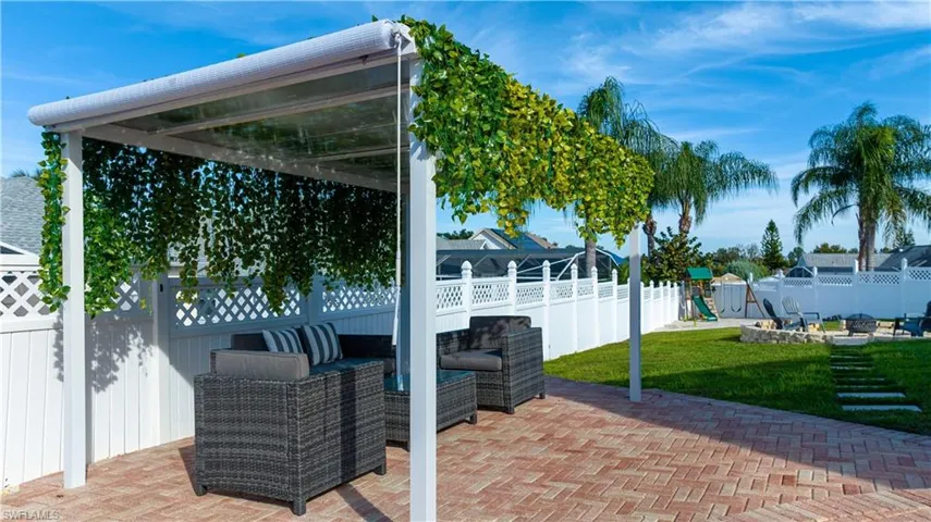 Fenced backyard featuring an outdoor living space and a patio