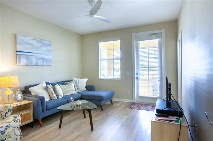 Living area featuring light wood finished floors and a ceiling fan