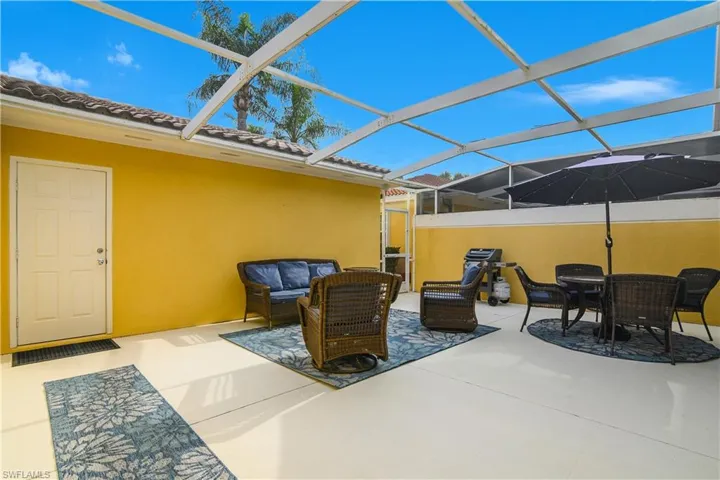 View of patio / terrace featuring outdoor lounge area, a lanai, a grill, and a sunroom