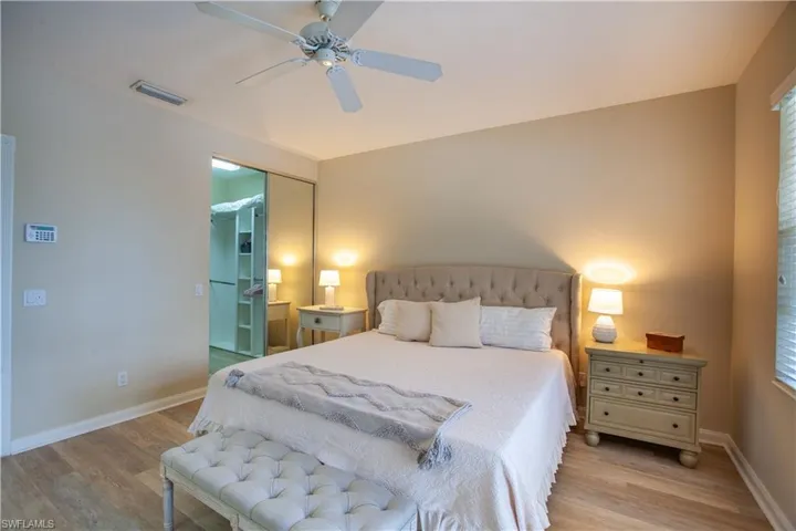 Bedroom featuring light wood finished floors, a ceiling fan, and a closet