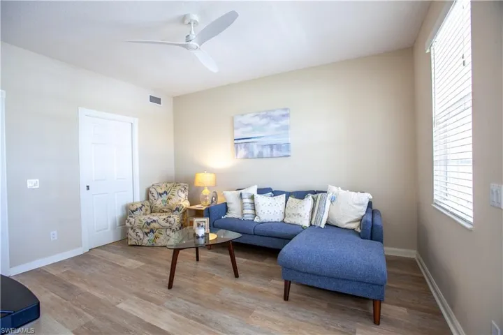 Living area with wood finished floors and a ceiling fan