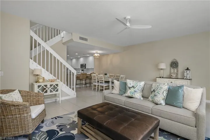Living room featuring a ceiling fan and tile patterned flooring