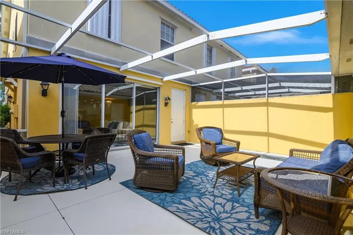 View of patio / terrace with a sunroom, glass enclosure, and an outdoor living / dining area
