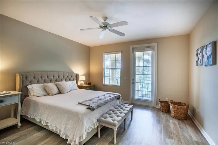 Bedroom with access to outside, light wood finished floors, and a ceiling fan