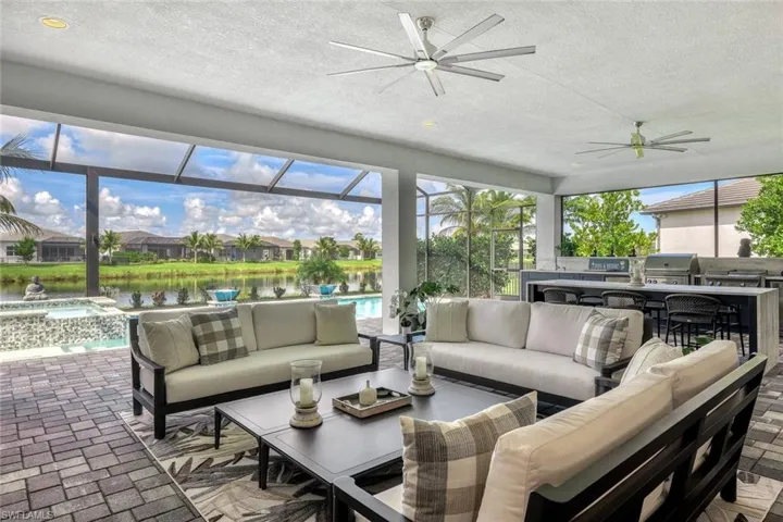 Lanai featuring a water view and ceiling fan