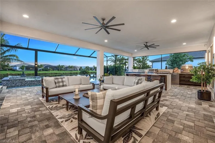 View of patio / terrace with an outdoor living space, an outdoor kitchen, and ceiling fan