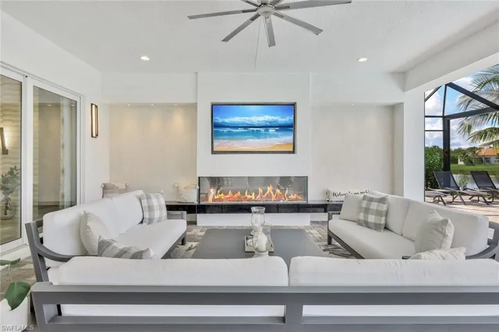 Living room featuring ceiling fan and fireplace