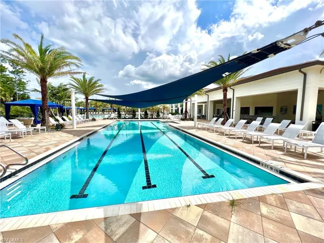 View of lap swimming pool featuring a patio area