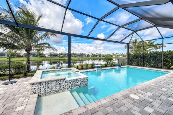 View of pool with an in ground hot tub, a patio, and panoramic screen enclosure