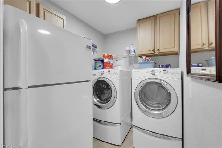 Laundry area with washing machine and dryer and cabinet space, 2nd refrigerator, easy access to garage