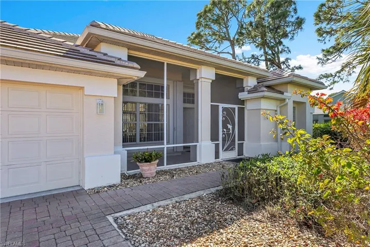 Property entrance featuring a screened front porch, gutters, new carriage lighting and destinctive architectural details