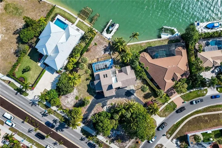 Aerial view of property and surrounding area with a large body of water
