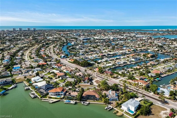 Aerial perspective of suburban area featuring a nearby body of water