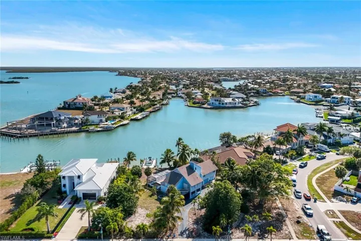 Aerial perspective of suburban area with a large body of water
