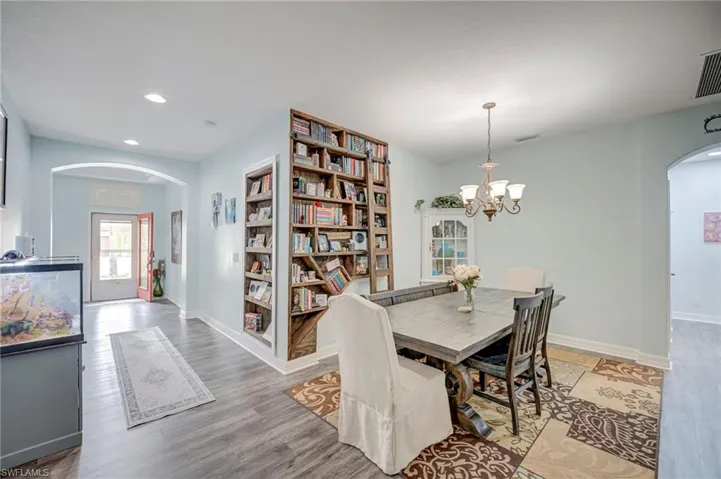 Formal Dining Area with view of Front Door.  Customized built-in book shelves with ladder