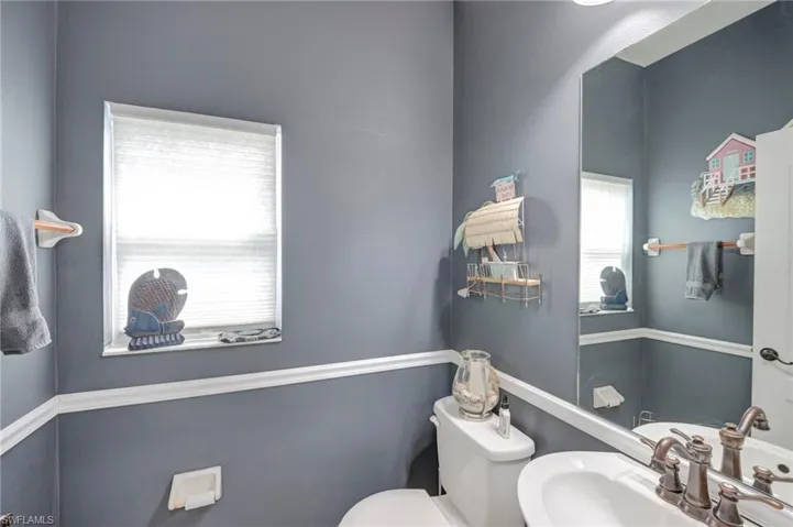 Half Bath by Den/Exercise Room.