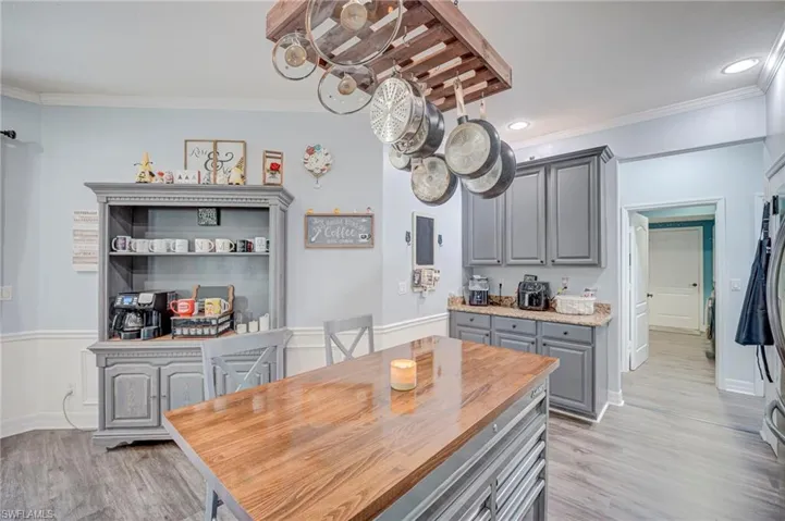 Custom woodwork and trim carried to kitchen!  Custom pot/pan holder