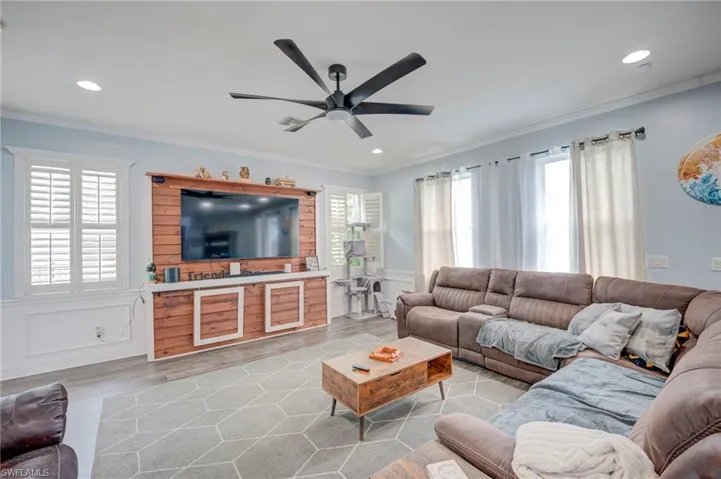 Exquisite custom woodwork throughout, featuring plantation shutters, crown molding, and elegant chair rails.
