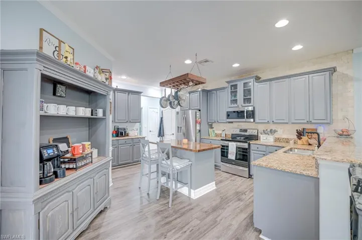 Granite Counter tops, Center Island, Tumbled Marble accent wall.