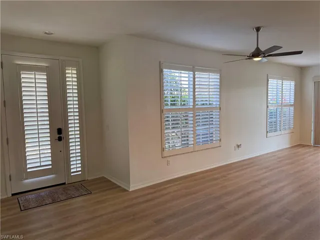 Foyer entrance with a wealth of natural light, hardwood / wood-style floors, and ceiling fan