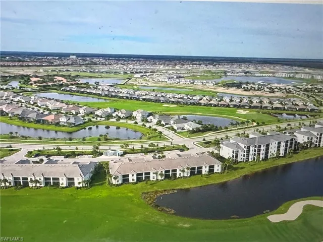 View of property location featuring a large body of water and nearby suburban area