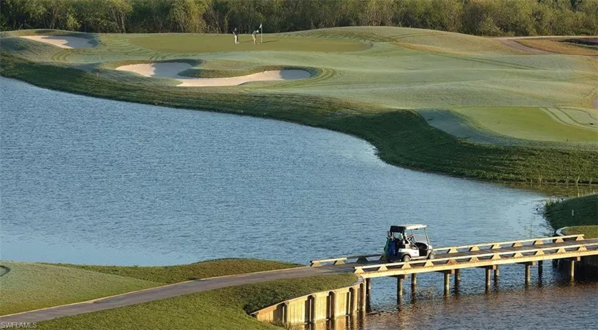 Dock featuring view of golf course and a water view