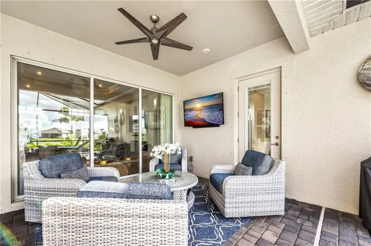 View of patio with ceiling fan and an outdoor living space