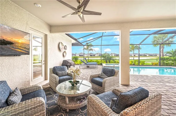 View of patio with an outdoor living space, area for grilling, and a lanai