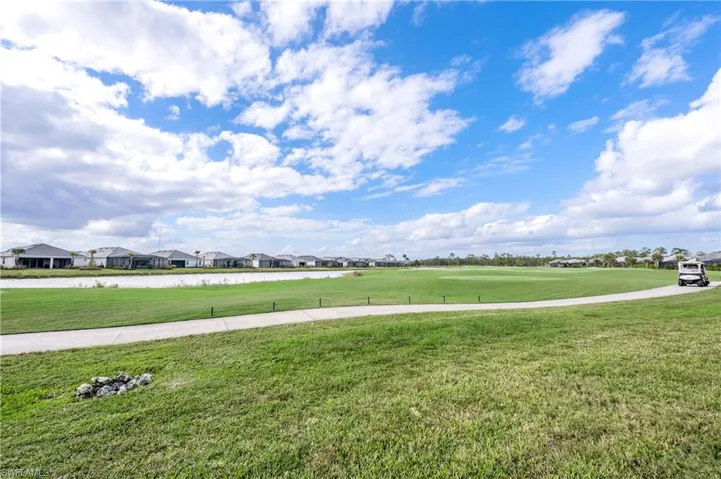 View of home's community with a lawn