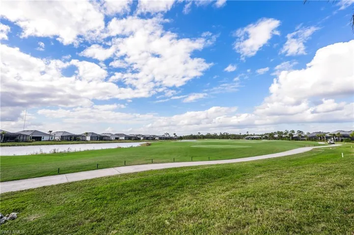Surrounding community featuring a water view and a yard