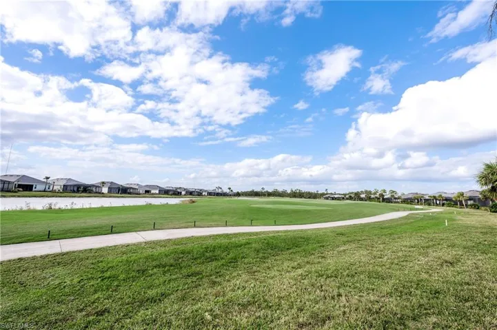 View of home's community featuring a yard and a water view